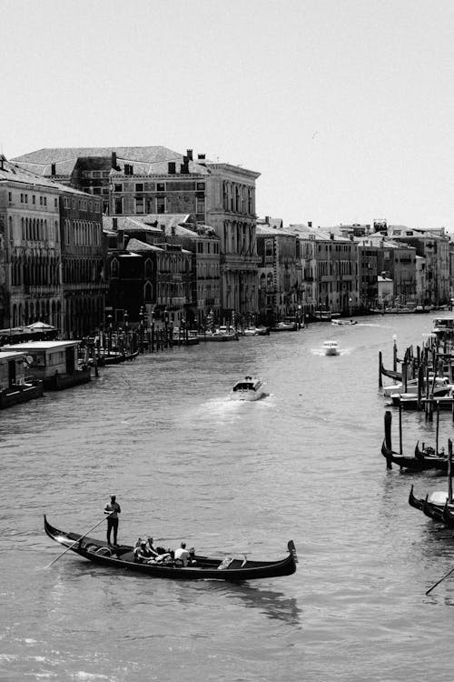 Gondola with Gondolier Sailing in Canal