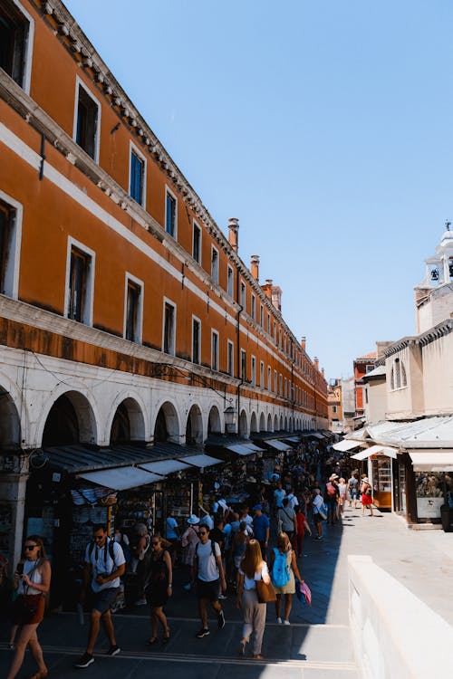 Old Town Building with Arcades and Tourists on a Bazaar