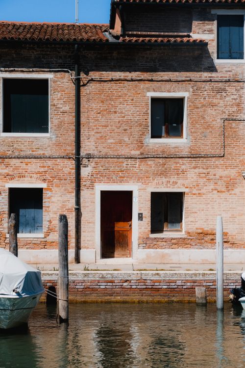 Free Historic brick building with canal view in Venice, Italy. Stock Photo