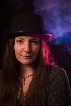 Elegant portrait of a woman in a fedora, highlighted by misty background lighting.. elegant, portrait, woman