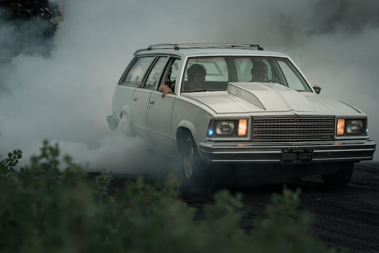 Men Driving In Old-Fashioned Car