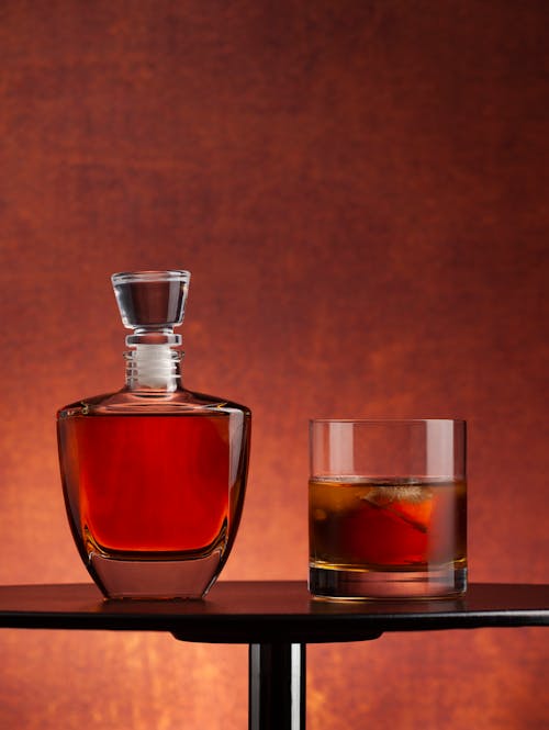 A Decanter and a Glass of Whiskey on a Table