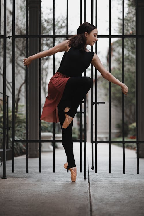 A Woman in Black Tank Top Ballet Dancing