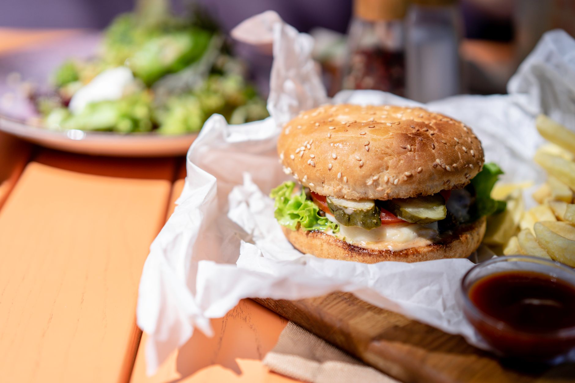 Close-up of a fast-food burger and fries on a tray