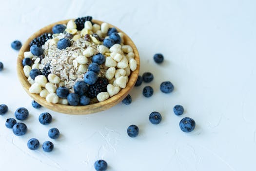 Nutrient-rich breakfast bowl with oats, blueberries, and puffed grains on a white background.
