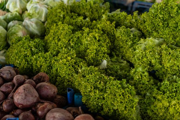 Leafy greens and beets at a market stall — photo by Atlantic Ambience on Pexels