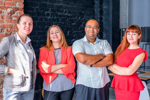 Professional group of colleagues standing confidently, showcasing teamwork and diversity in an office setting.
