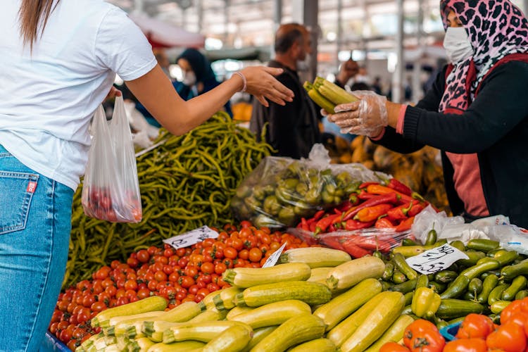 Woman Buying Vegetables In The Market