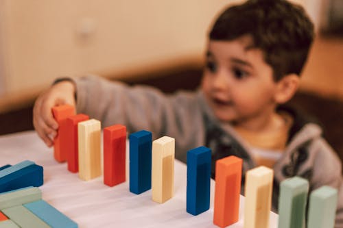 Boy Playing with Wooden Blocks