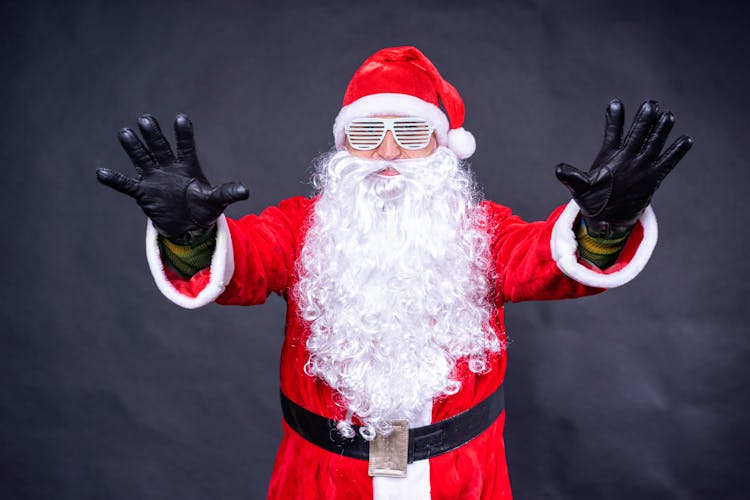 Man In A Santa Claus Costume With Funny Glasses