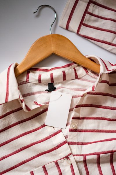Striped shirt on a wooden hanger by Atlantic Ambience on Pexels