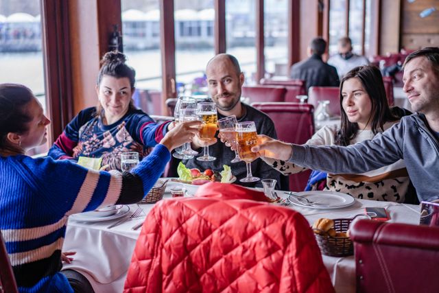 Friends clinking glasses at a table by the window. Photo by Atlantic Ambience on Pexels