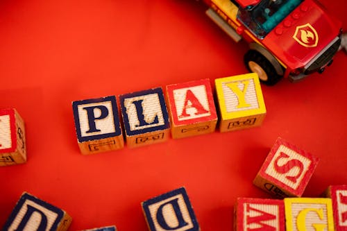 Photo of Letter Cubes against a Red Background