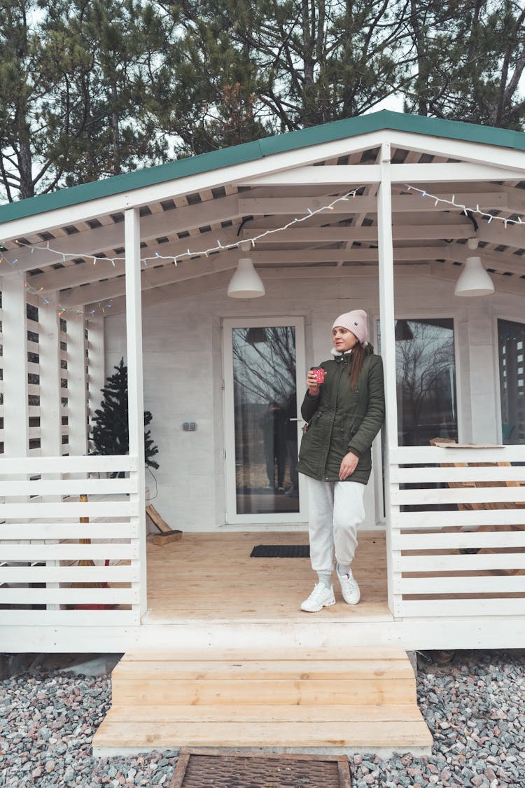 Woman Drinking Coffee On Porch