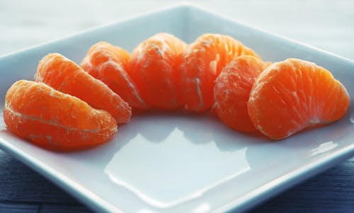 Orange Fruit on White Ceramic Saucer