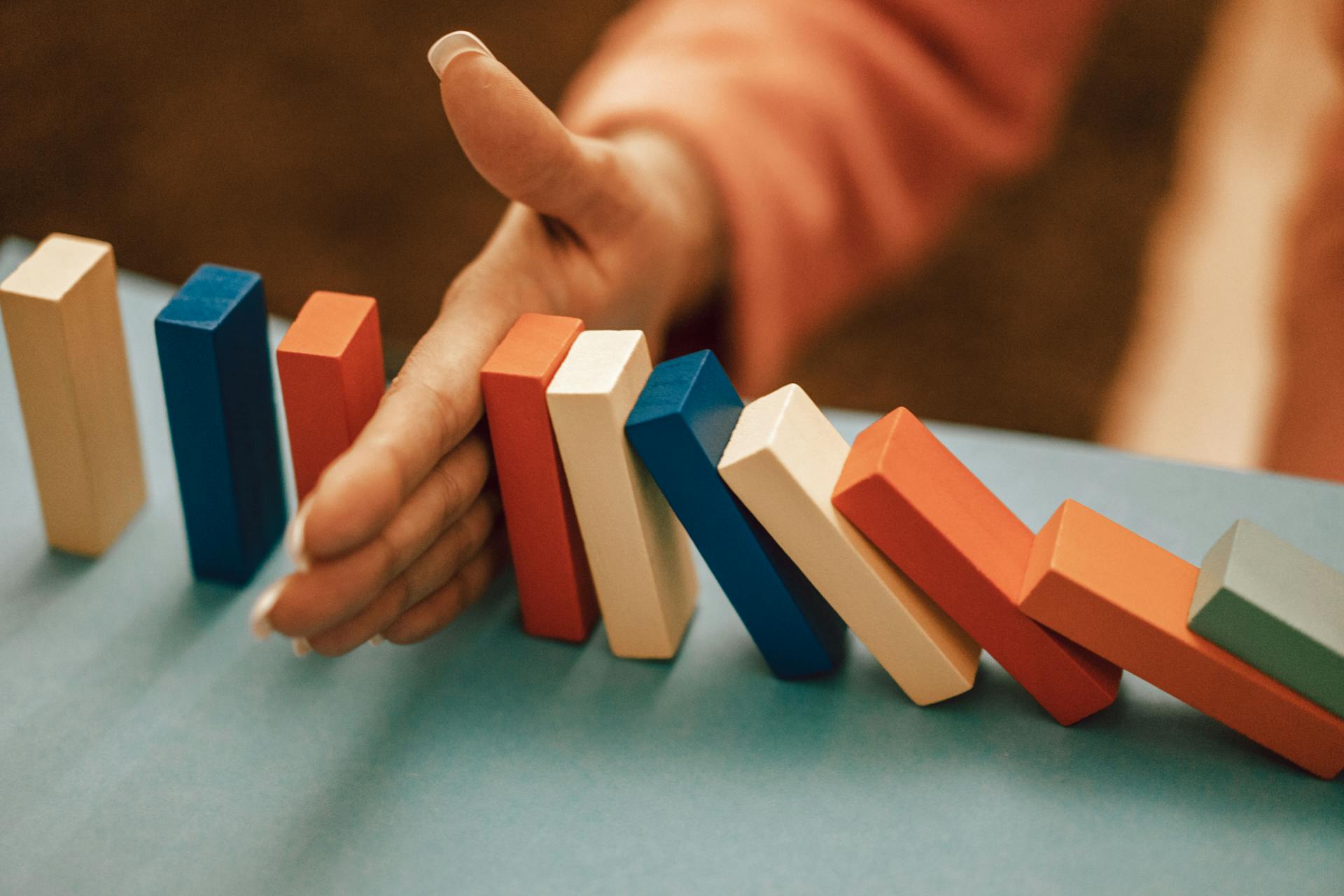 Hand Stopping Domino Effect