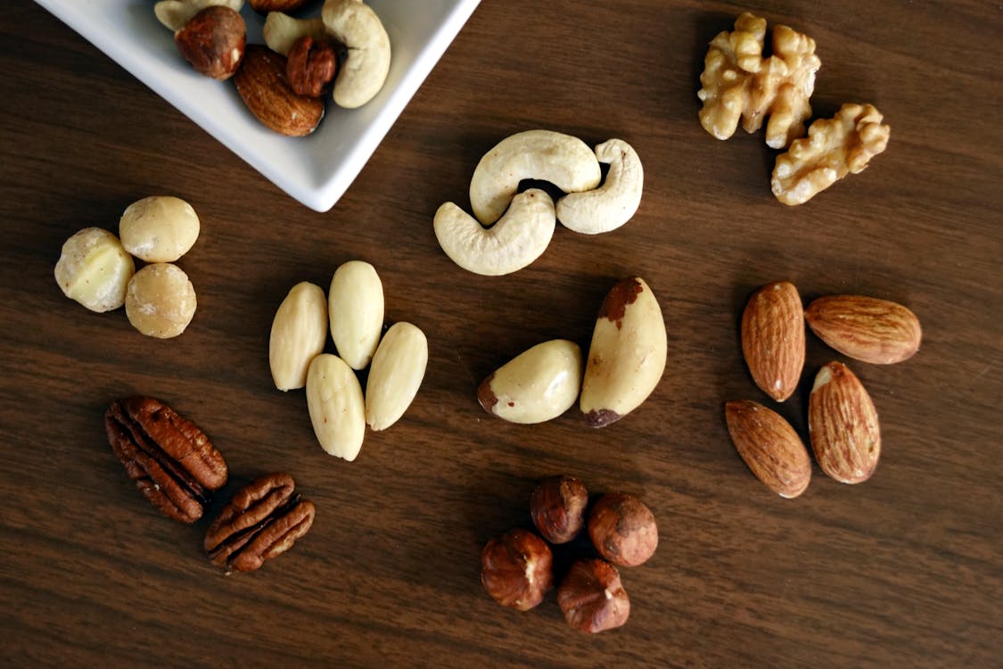 Variety of nuts- cashew, almond, walnut and more on a brown board