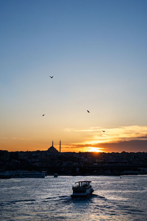 Free Silhouette of a ferryboat on the Bosphorus with Istanbul skyline during a beautiful sunset. Stock Photo