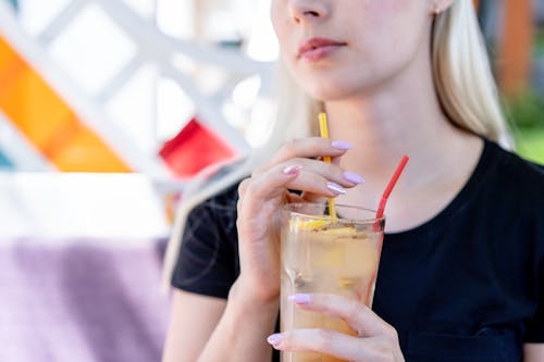 A Close-Up Shot of a Woman Drinking Juice