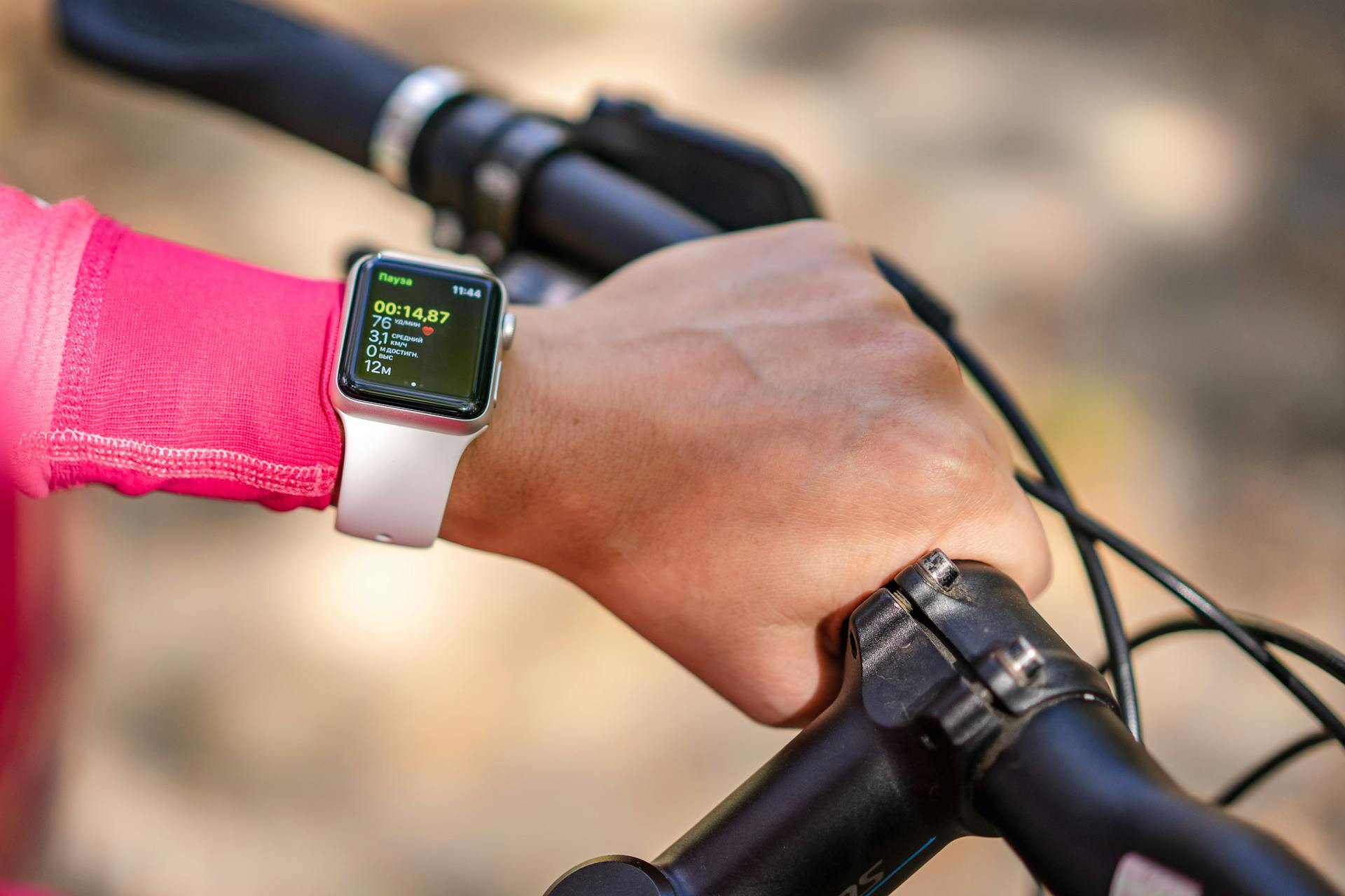 A Biker Wearing a Smart Watch with Apps Showing on Screen