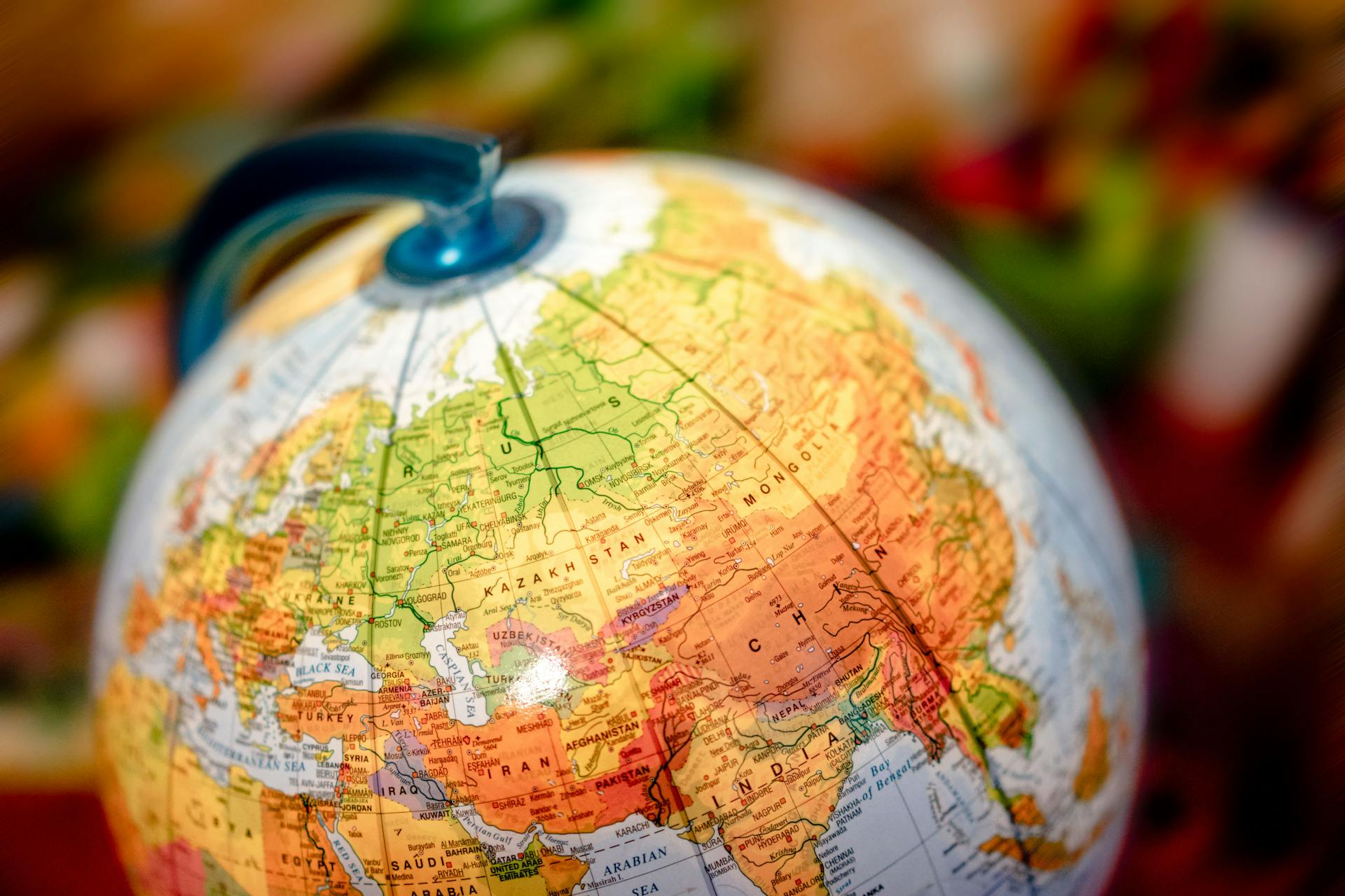 Vibrant close-up of a globe displaying the Eurasian continent, featuring countries like China and Russia.