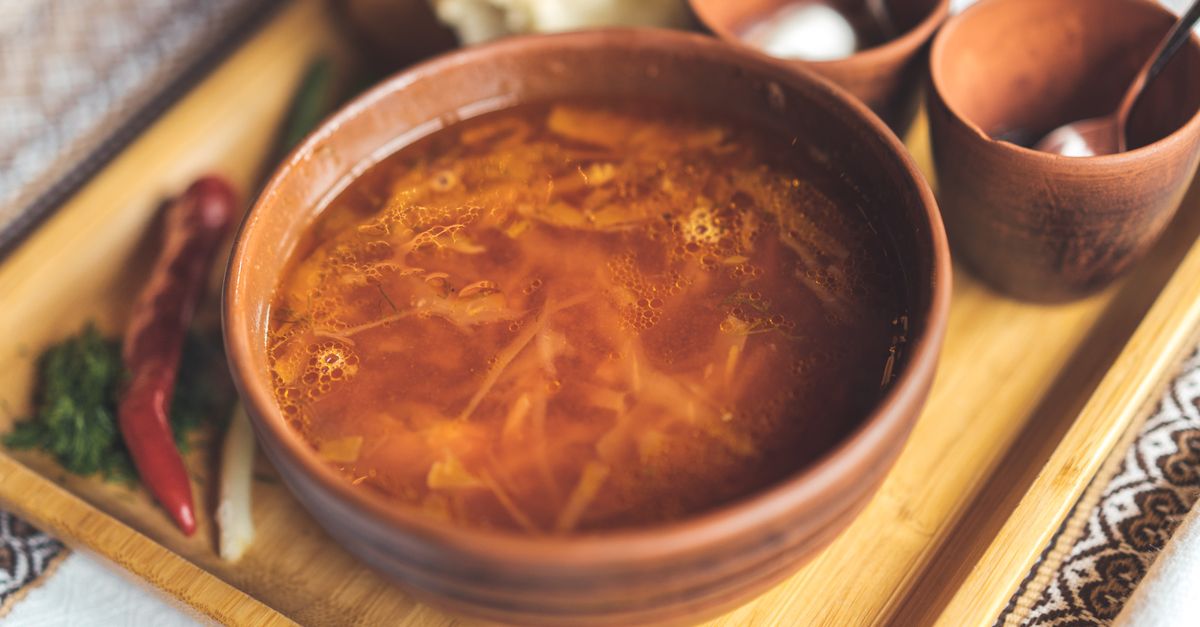 traditional Ewe fufu and groundnut soup served in a wooden bowl