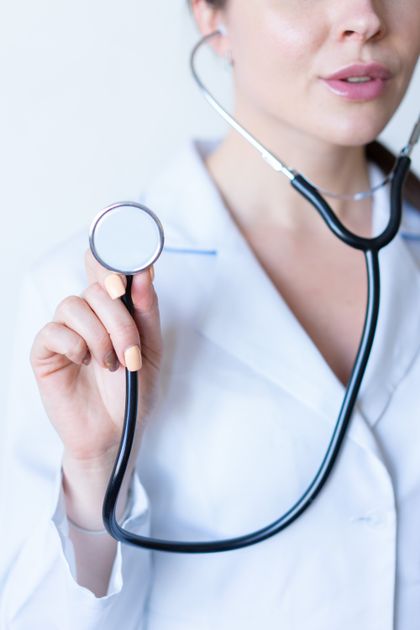 Doctor holding stethoscope — health insurance explained