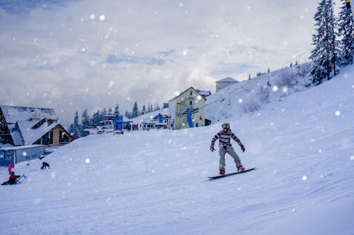 Photo of a Person Snowboarding in Winter