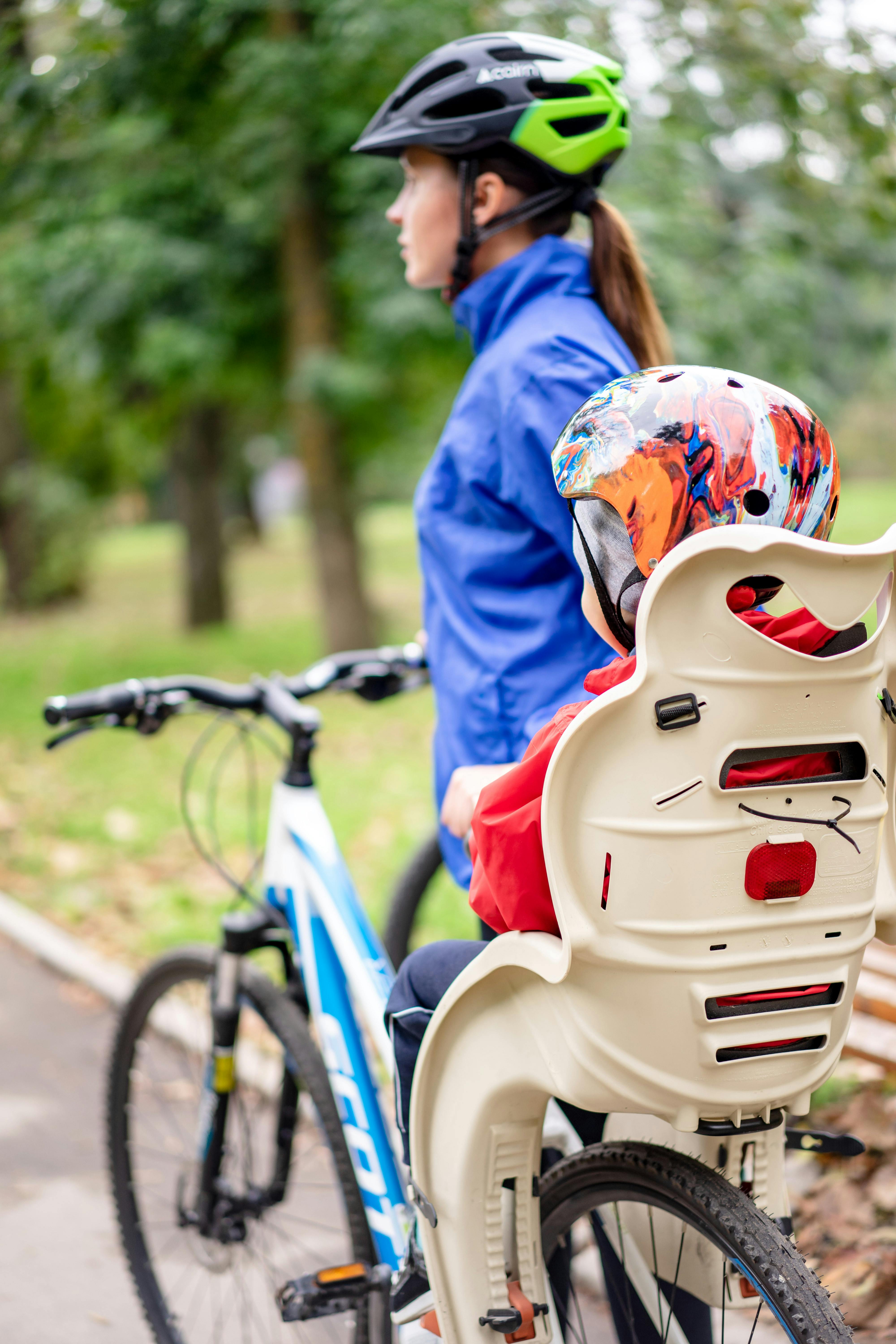 Mother and child enjoying a fun, safe bicycle ride together in a park.