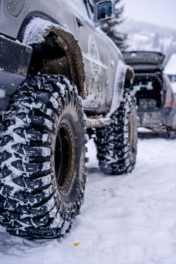 Off-road truck on snow-covered terrain for an overlanding suspension guide
