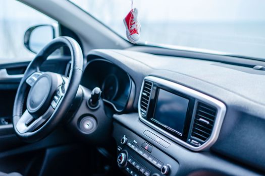 Close-up view of a modern car interior focusing on the steering wheel and dashboard.
