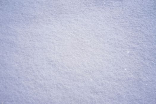 Detailed close-up of fresh snow showcasing its texture, perfect for winter wallpaper.