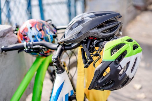 Close-up of brightly colored bicycle helmets resting on bike handlebars, emphasizing safety.