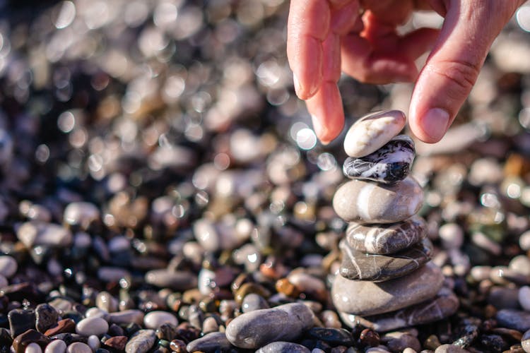 Hand Stacking Smooth Pebbles