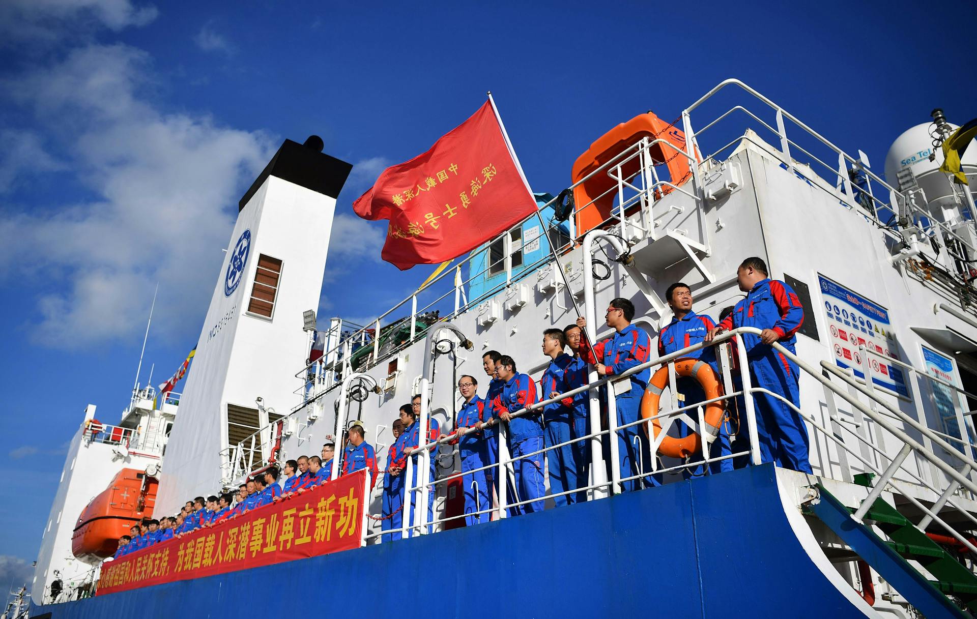 People in Blue Uniform Standing on Blue and White Ship
