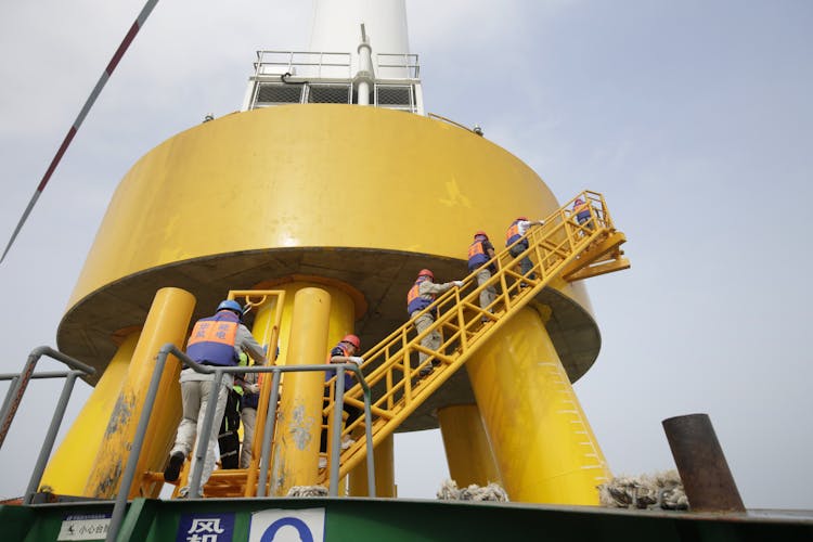 Workers Walking Upstairs On Gas Instalation