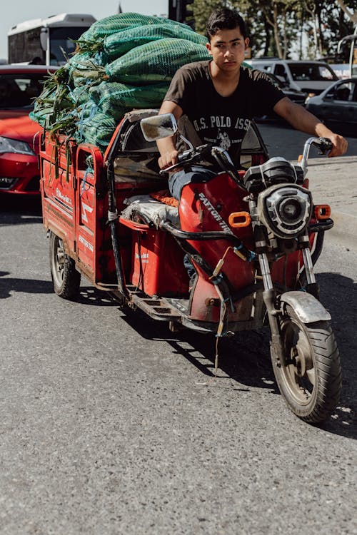 A Man Riding a Motorcycle with Sacks