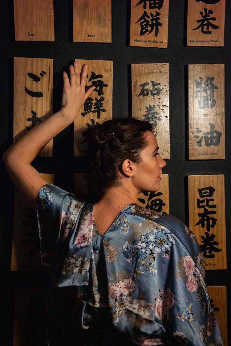 Woman Touching Decorated Wall