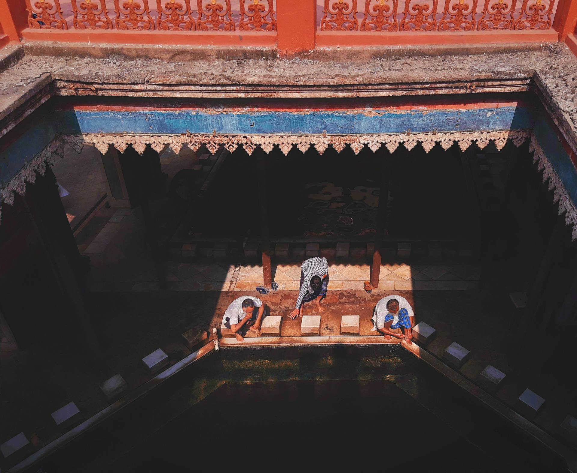 High angle view of people performing wudu, an Islamic ablution ritual, in Kolkata mosque.