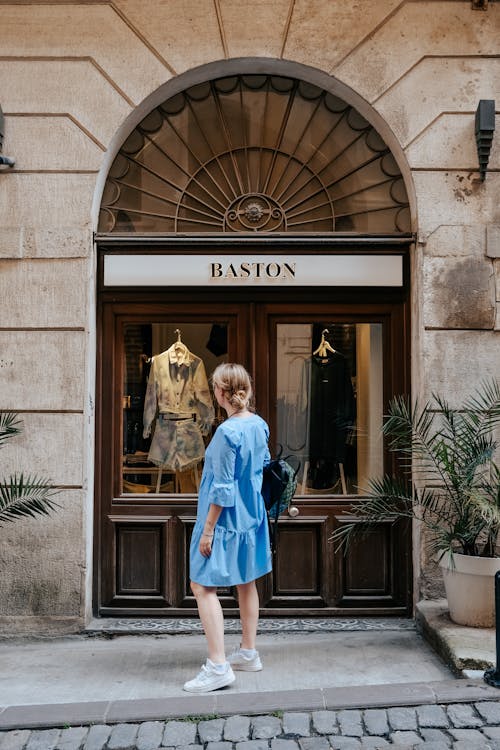 Free Photo of a Woman Standing in Front of a Shop Window Display Stock Photo