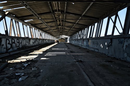 Gray Concrete Road Under Gray Metal Bridge