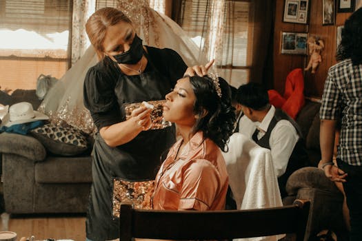 Bride having makeup done by an artist in a warm and cozy setting, preparing for a special occasion.