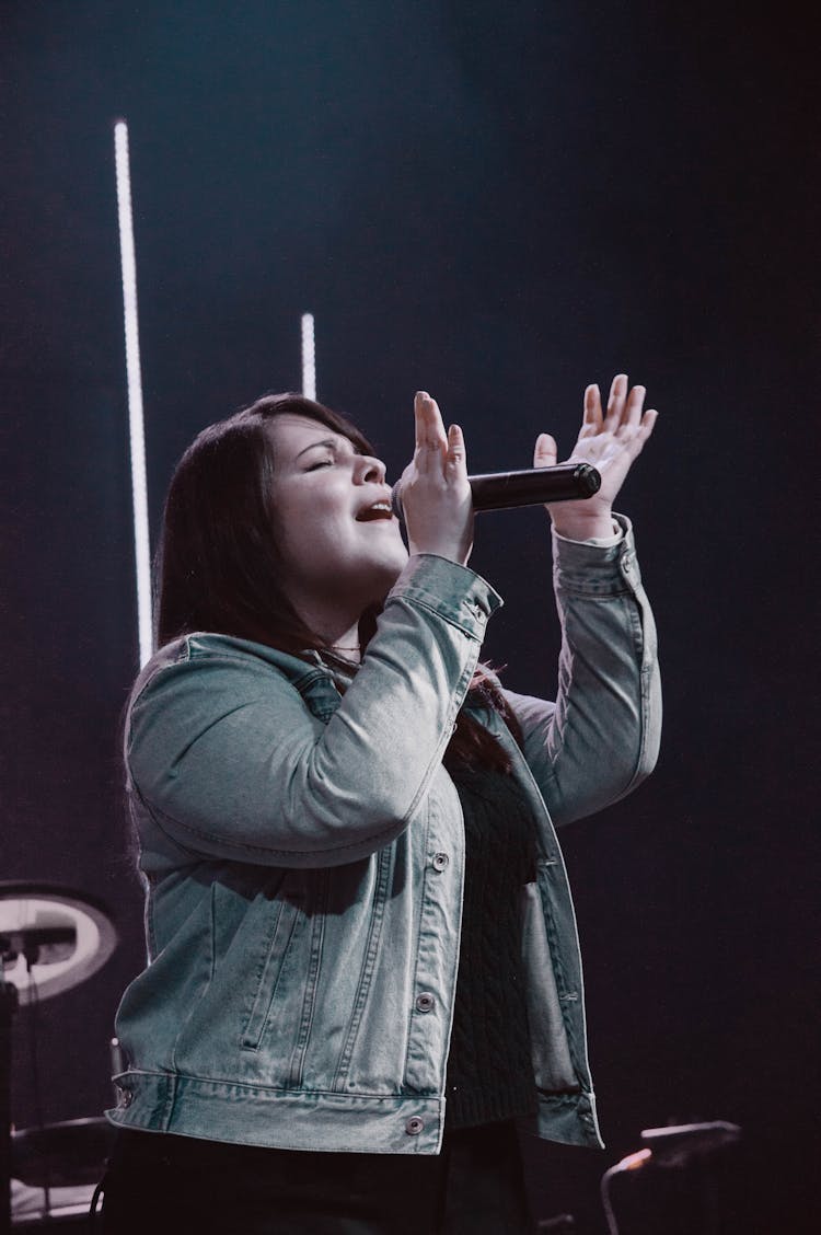 Singing Woman Throwing Microphone In Air