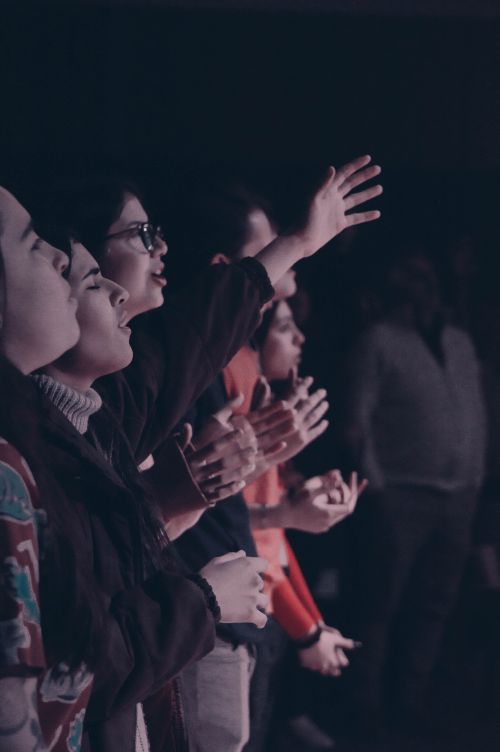 Free A group of people participating in a worship event with hands raised, captured in Mendoza, Argentina. Stock Photo