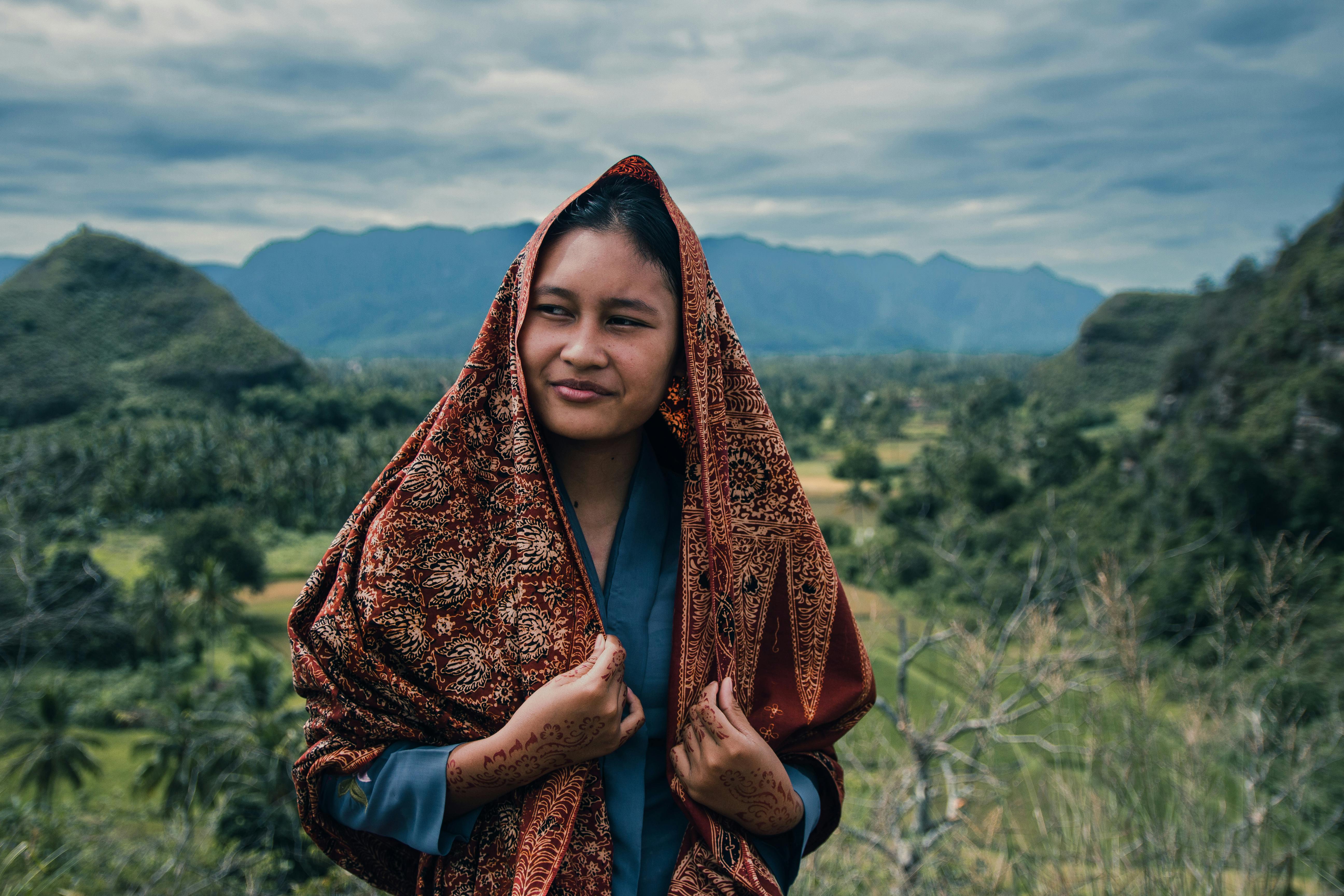 portrait of a woman in a countryside with a decorative headscarf