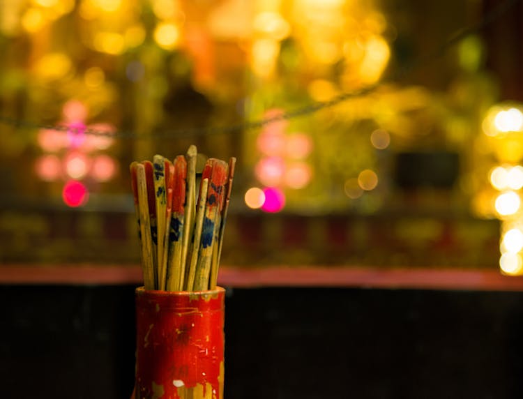 Close-up Of Fortune Sticks In Jar