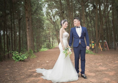 Wedding Couples Between Tall Trees