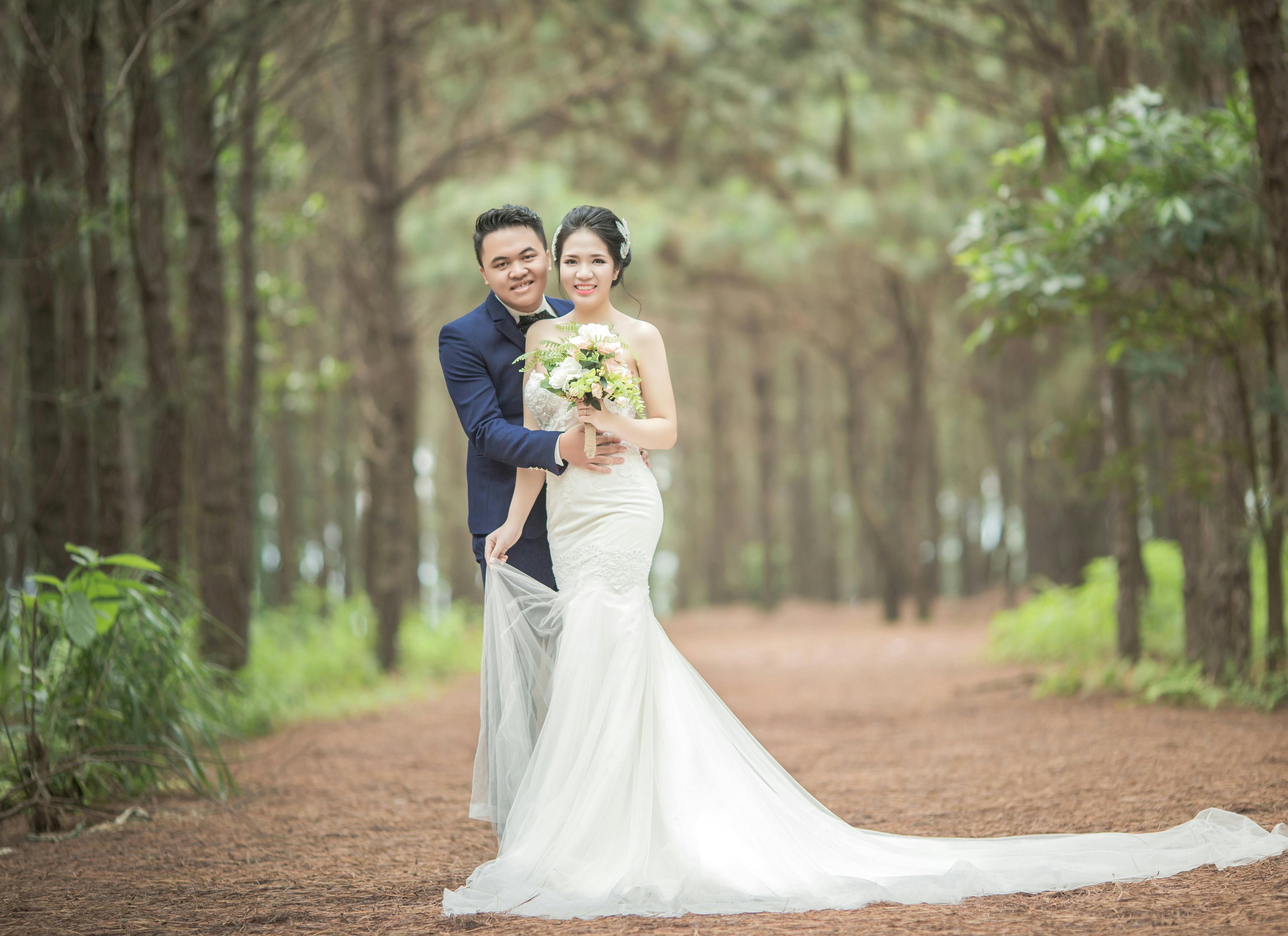 Man Wearing Black Suit Jacket and Women Wearing White Wedding