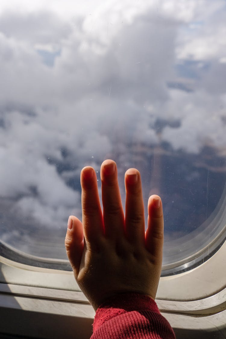 Hand On An Airplane Window