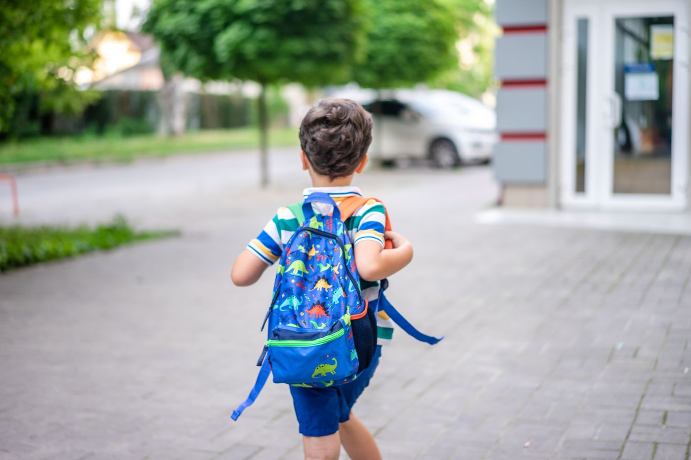 Child walking to school with a backpack — photo by Atlantic Ambience on Pexels